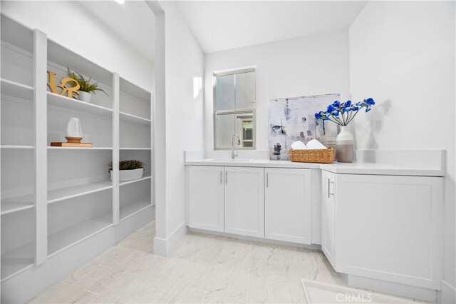 bar with sink and white cabinets