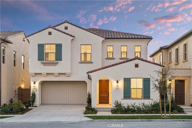 mediterranean / spanish-style home featuring a garage