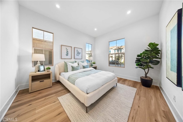 bedroom featuring hardwood / wood-style floors and multiple windows