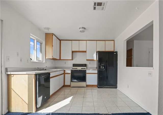 kitchen featuring light tile patterned flooring, sink, white cabinetry, and black appliances