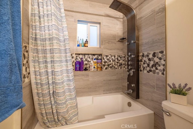 bathroom featuring shower / bathtub combination with curtain and toilet