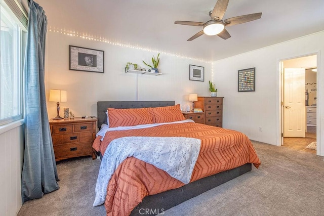 bedroom featuring carpet flooring, ceiling fan, and ensuite bathroom