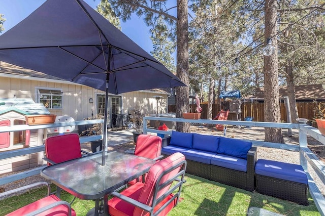 view of patio with outdoor lounge area and a playground