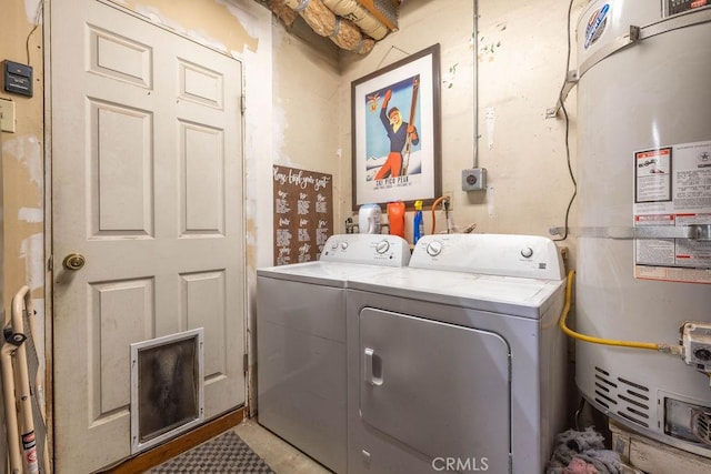 clothes washing area featuring washer and clothes dryer and gas water heater