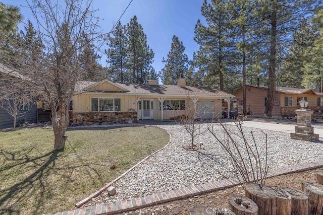 single story home with a garage and a front lawn