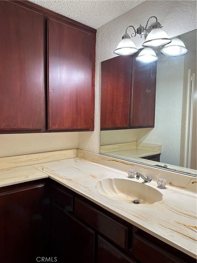 bathroom with vanity and a textured ceiling