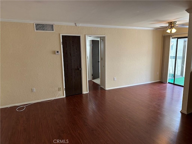 empty room featuring ceiling fan, dark hardwood / wood-style flooring, and crown molding