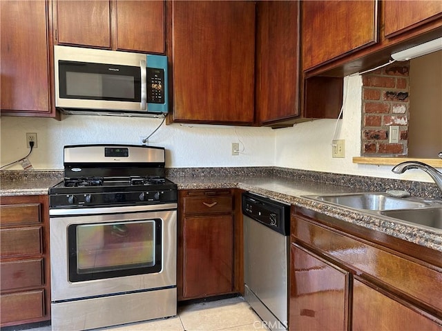 kitchen featuring sink, light tile patterned floors, and stainless steel appliances