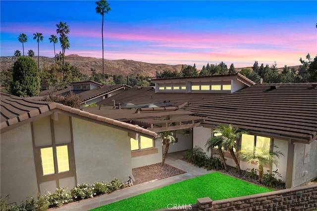 exterior space with a mountain view and a patio