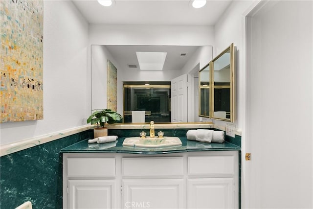 bathroom with vanity and walk in shower