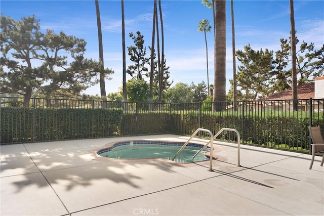 view of swimming pool featuring a patio area and an in ground hot tub