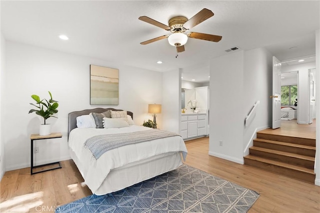 bedroom featuring ceiling fan, wood-type flooring, and connected bathroom