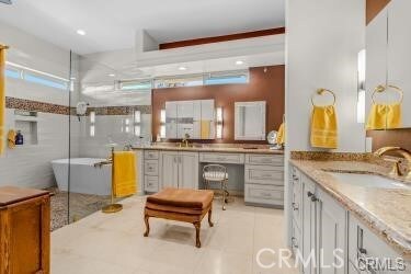 bathroom featuring tile patterned floors, tile walls, sink, and a tub