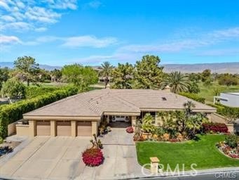 ranch-style house with a front yard and a garage