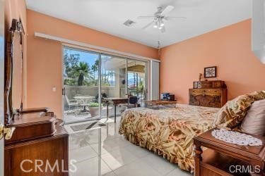 bedroom featuring ceiling fan, light tile patterned flooring, and access to exterior