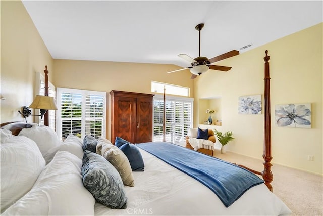 carpeted bedroom with ceiling fan and vaulted ceiling