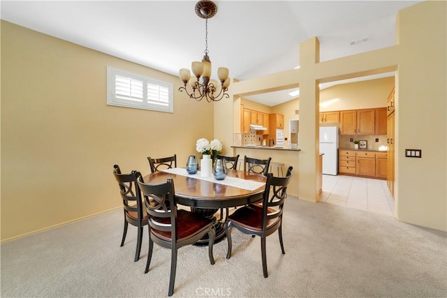 carpeted dining space with vaulted ceiling and a notable chandelier