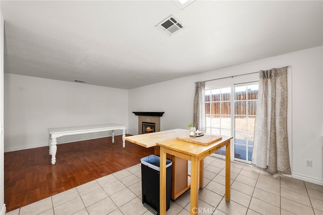 tiled dining area with a fireplace