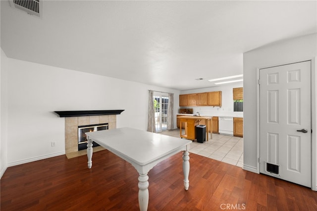 playroom featuring light hardwood / wood-style floors and a fireplace