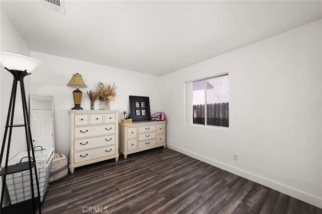 unfurnished bedroom with dark hardwood / wood-style flooring