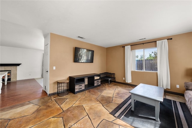 living room featuring a tile fireplace