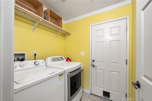 laundry area with washer and dryer, light tile patterned flooring, and ornamental molding