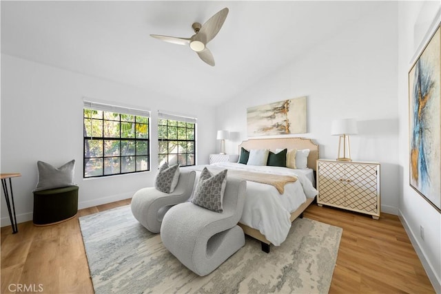 bedroom with wood-type flooring, ceiling fan, and lofted ceiling