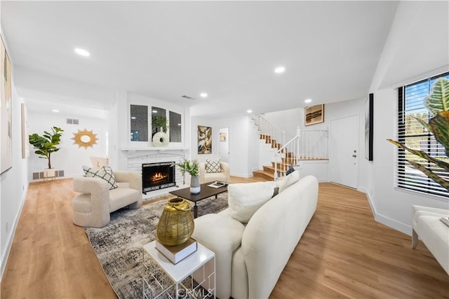 living room with a fireplace and light hardwood / wood-style flooring