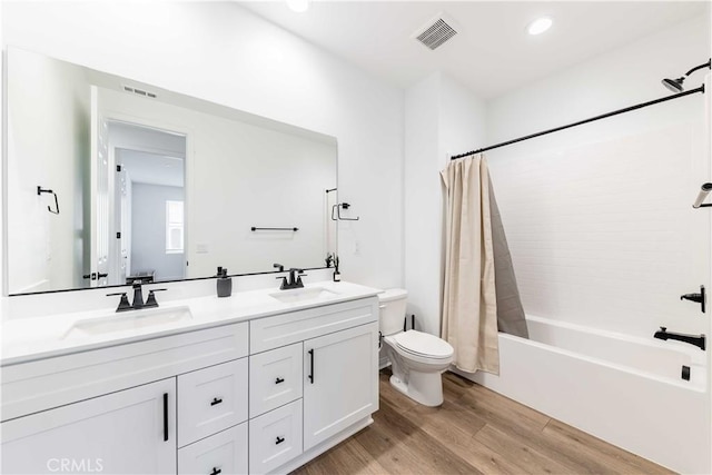 full bathroom with shower / bath combination with curtain, toilet, wood-type flooring, and vanity