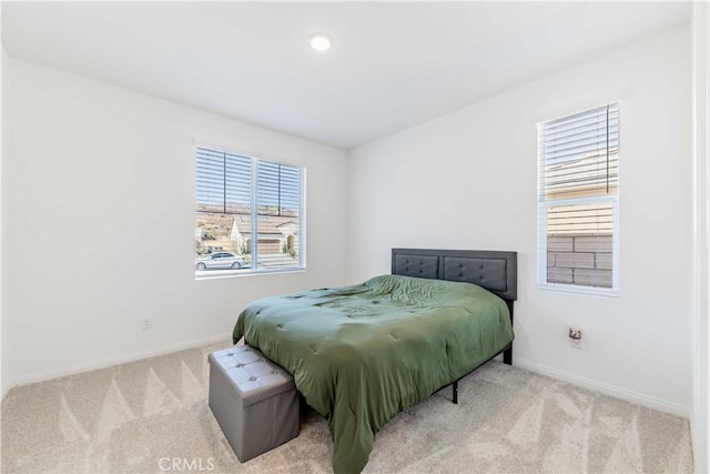 bedroom featuring light carpet