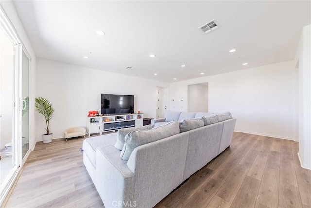 living room with light hardwood / wood-style floors