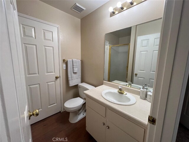 bathroom featuring hardwood / wood-style floors, vanity, and toilet