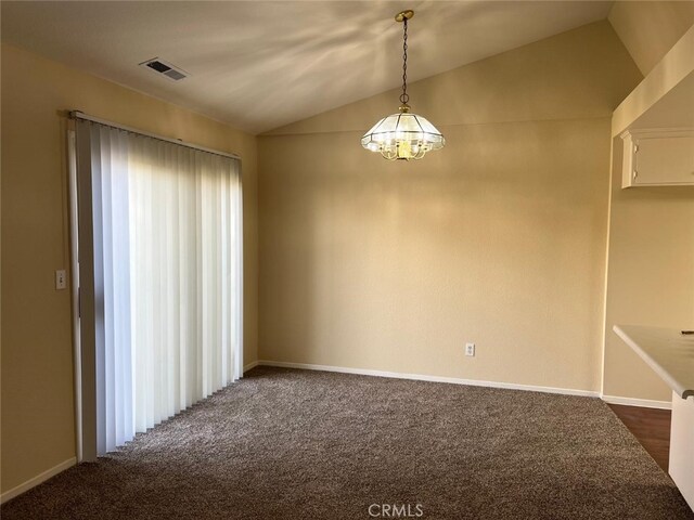 carpeted spare room with a notable chandelier and lofted ceiling