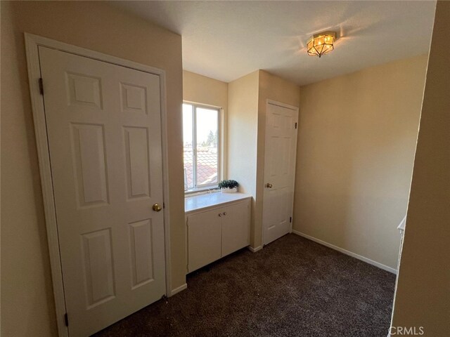 interior space with dark colored carpet