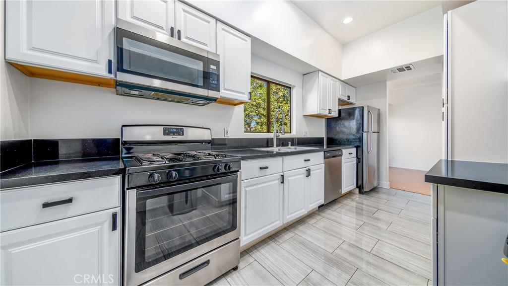 kitchen featuring white cabinets, sink, and appliances with stainless steel finishes