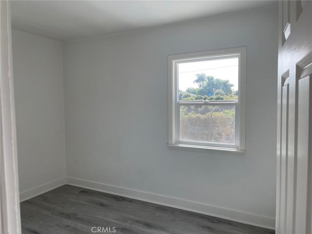 spare room with dark wood-type flooring