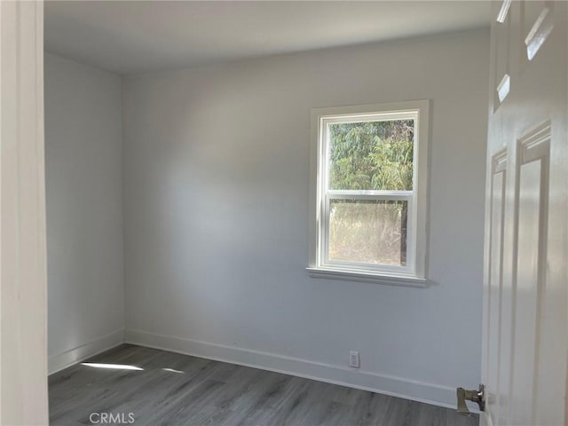 spare room with dark wood-type flooring