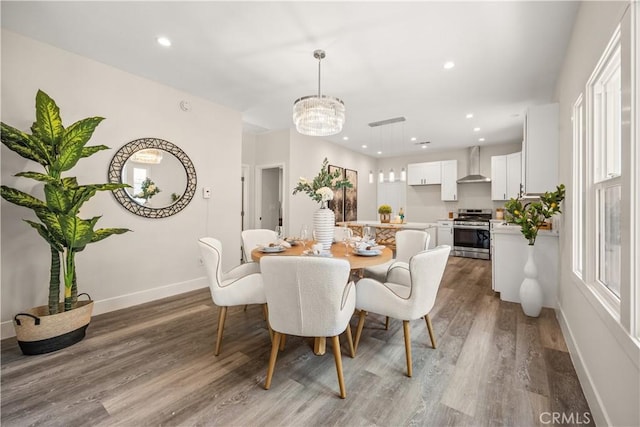 dining room featuring an inviting chandelier and hardwood / wood-style floors