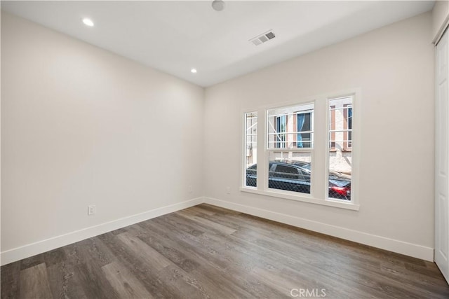 empty room with dark wood-type flooring