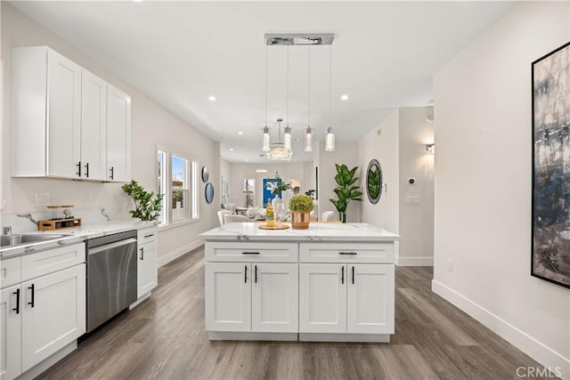 kitchen with decorative light fixtures, dishwasher, white cabinets, light stone counters, and a center island