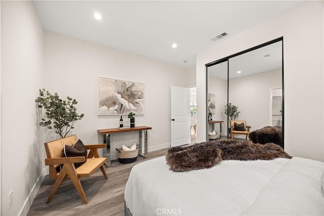 bedroom with a closet and hardwood / wood-style flooring