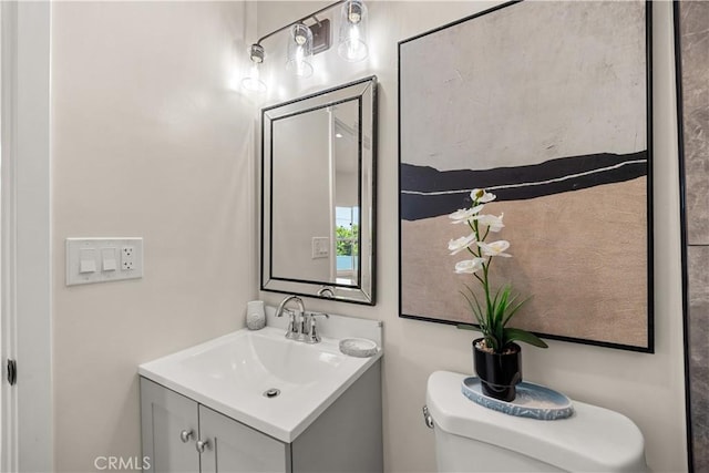 bathroom featuring toilet and vanity