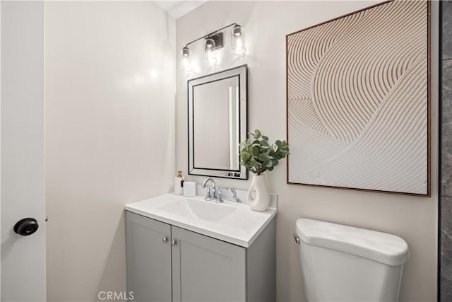 bathroom featuring toilet and vanity