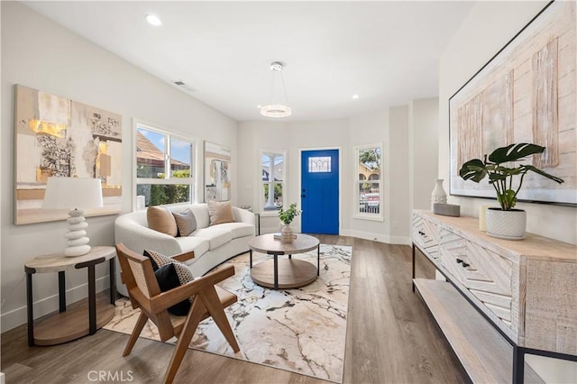 living room with a wealth of natural light and dark hardwood / wood-style flooring