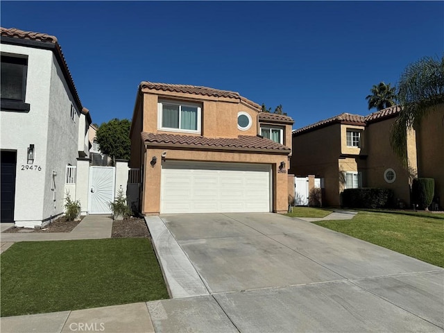 mediterranean / spanish home with a garage and a front lawn