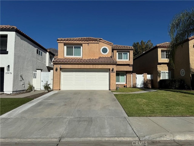 mediterranean / spanish-style home with a front lawn and a garage