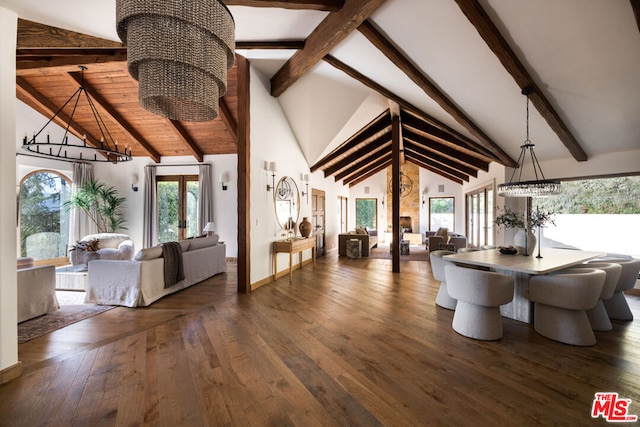 unfurnished dining area with a notable chandelier, beam ceiling, dark hardwood / wood-style flooring, and high vaulted ceiling