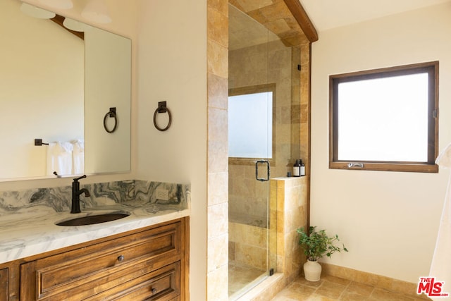 bathroom featuring tile patterned flooring, vanity, and an enclosed shower