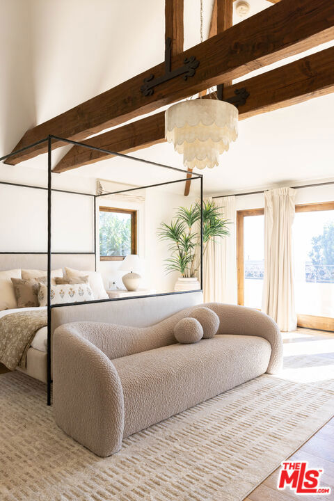 bedroom with beam ceiling