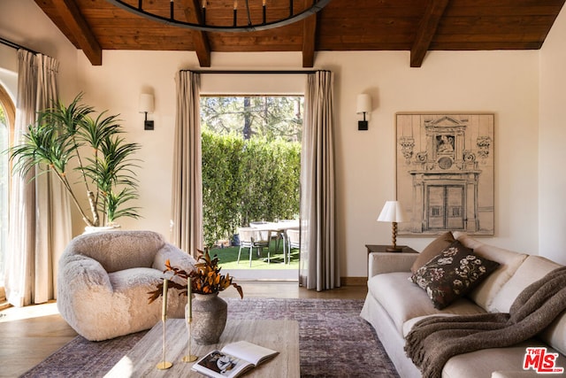 living area featuring beamed ceiling, wood-type flooring, and wooden ceiling